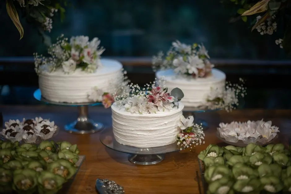 Białe torty weselne ozdobione kwiatami